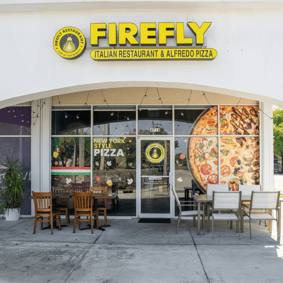 Firefly Italian Restaurant & Alfredo Pizza storefront with outdoor seating and large pizza window decals.