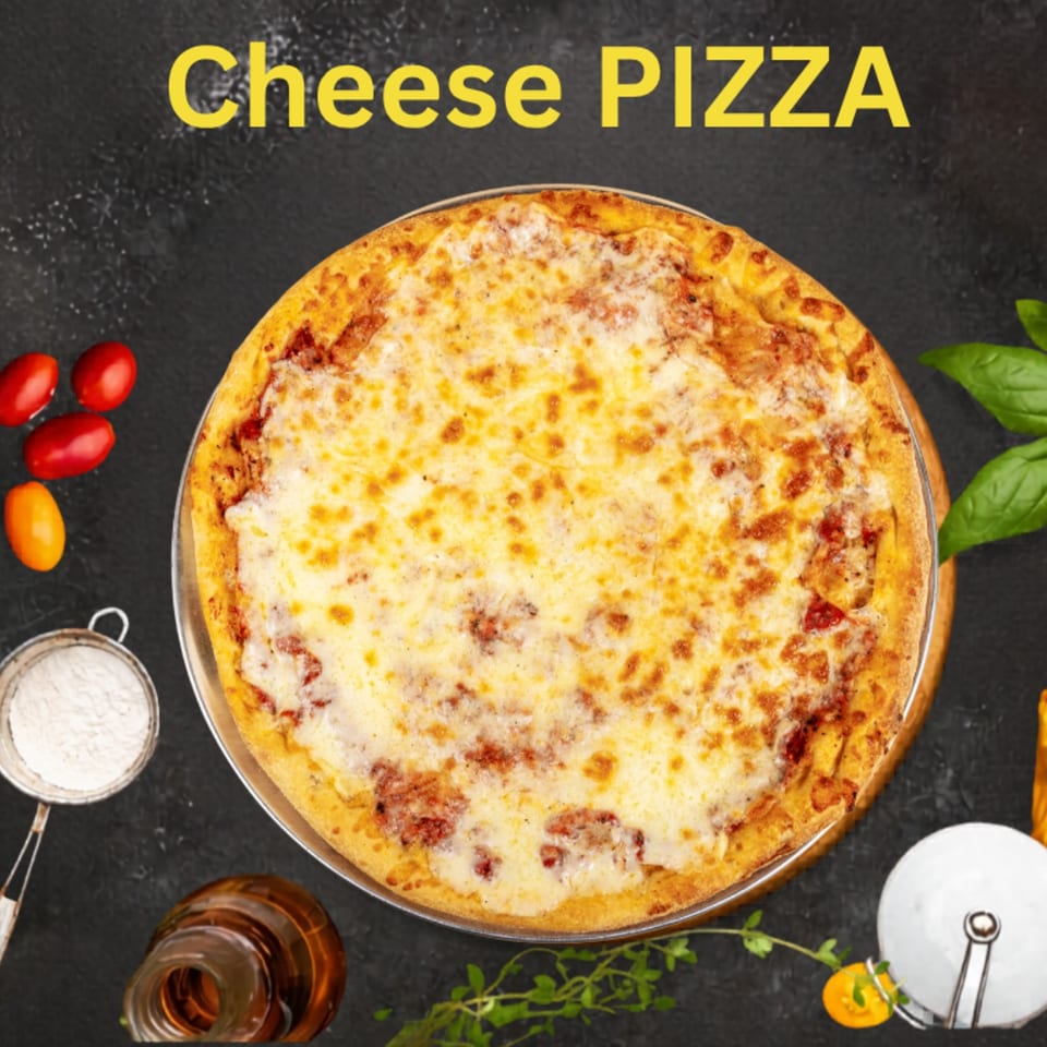 Cheese pizza with a golden crust on a metal tray, surrounded by tomatoes, basil, flour, and cooking utensils.